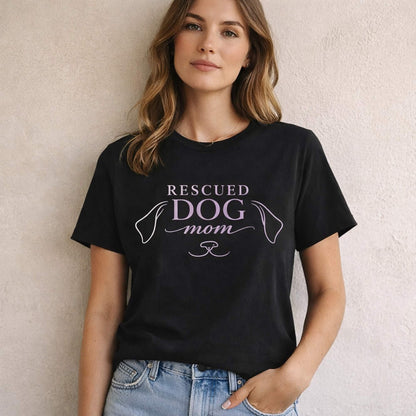 Woman wearing black “Rescued Dog Mom” t-shirt, minimalist dog line design, front view fit and style, premium dog lover apparel by Zevinity